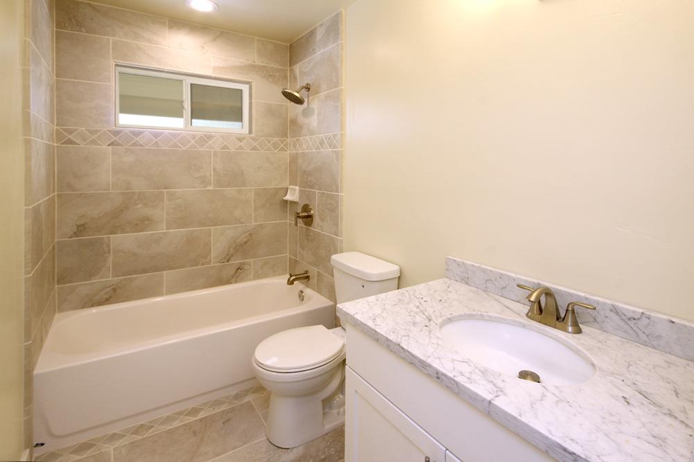 125 Charman Hill Road Aptos, CA 95003 - Photo 15 of 22 a bathroom with a granite countertop sink a toilet and bathtub