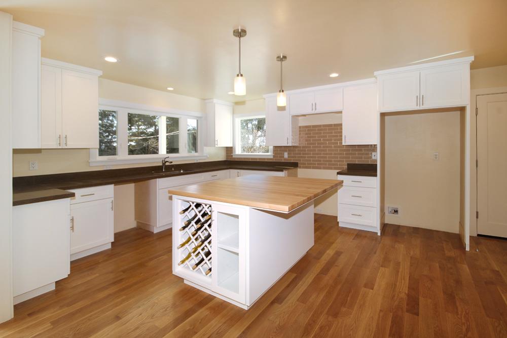 125 Charman Hill Road Aptos, CA 95003 - Photo 7 of 22 a kitchen with kitchen island granite countertop a sink appliances and cabinets