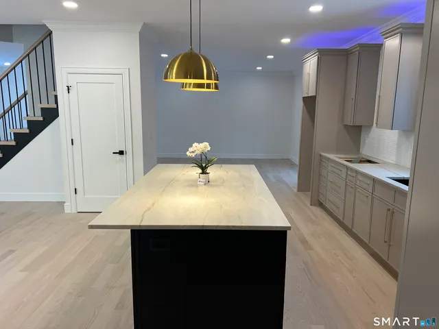 a view of kitchen and hall with wooden floor