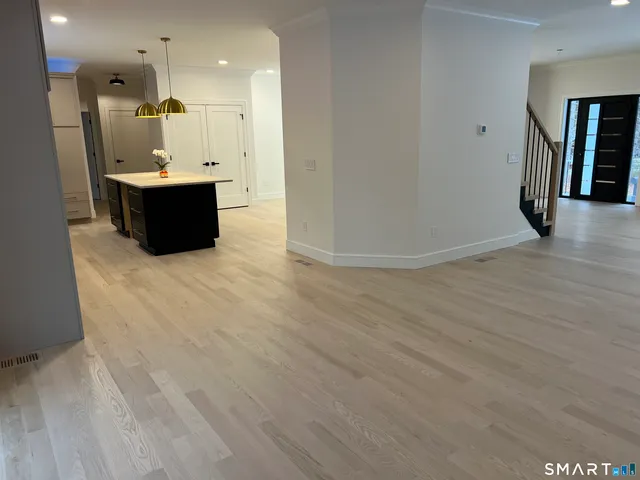 an entryway in a hall with an entryway and wooden floor