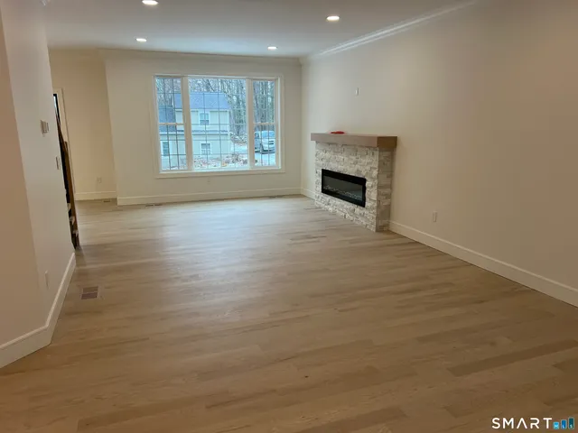 a living room with a furniture and a ceiling fan