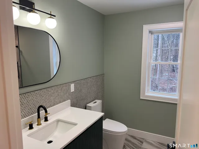 a view of a hallway with windows and chandelier