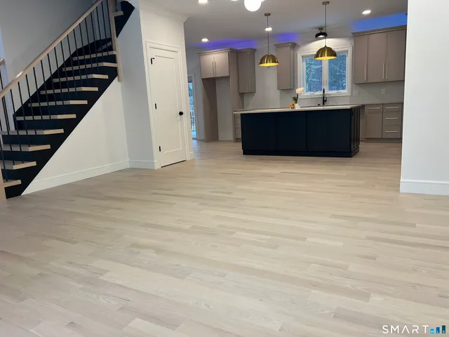 a kitchen with kitchen island granite countertop a sink and a stove