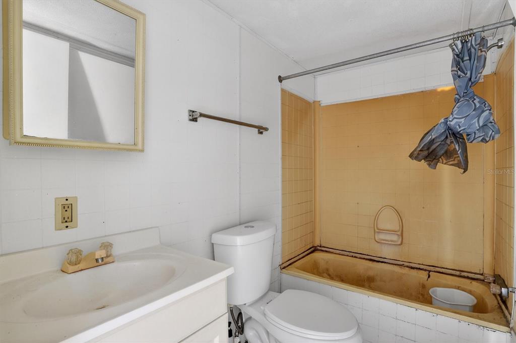 18441 Rigsby Road Spring Hill, FL 34610 - Photo 18 of 23 a bathroom with a sink a toilet and shower