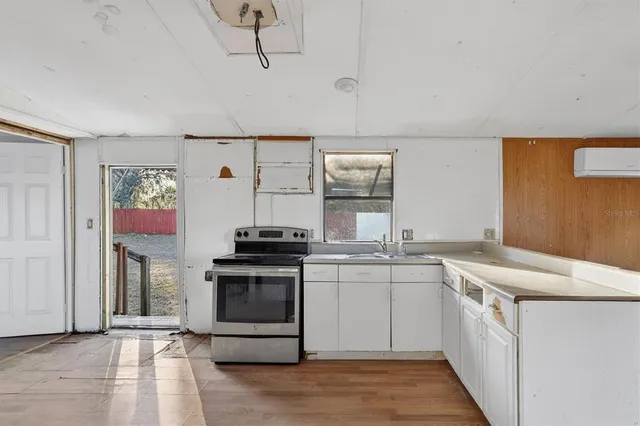 a kitchen with cabinets and wooden floor