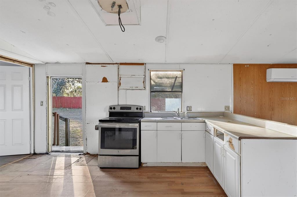 18441 Rigsby Road Spring Hill, FL 34610 - Photo 8 of 23 a kitchen with a stove top oven sink and cabinets