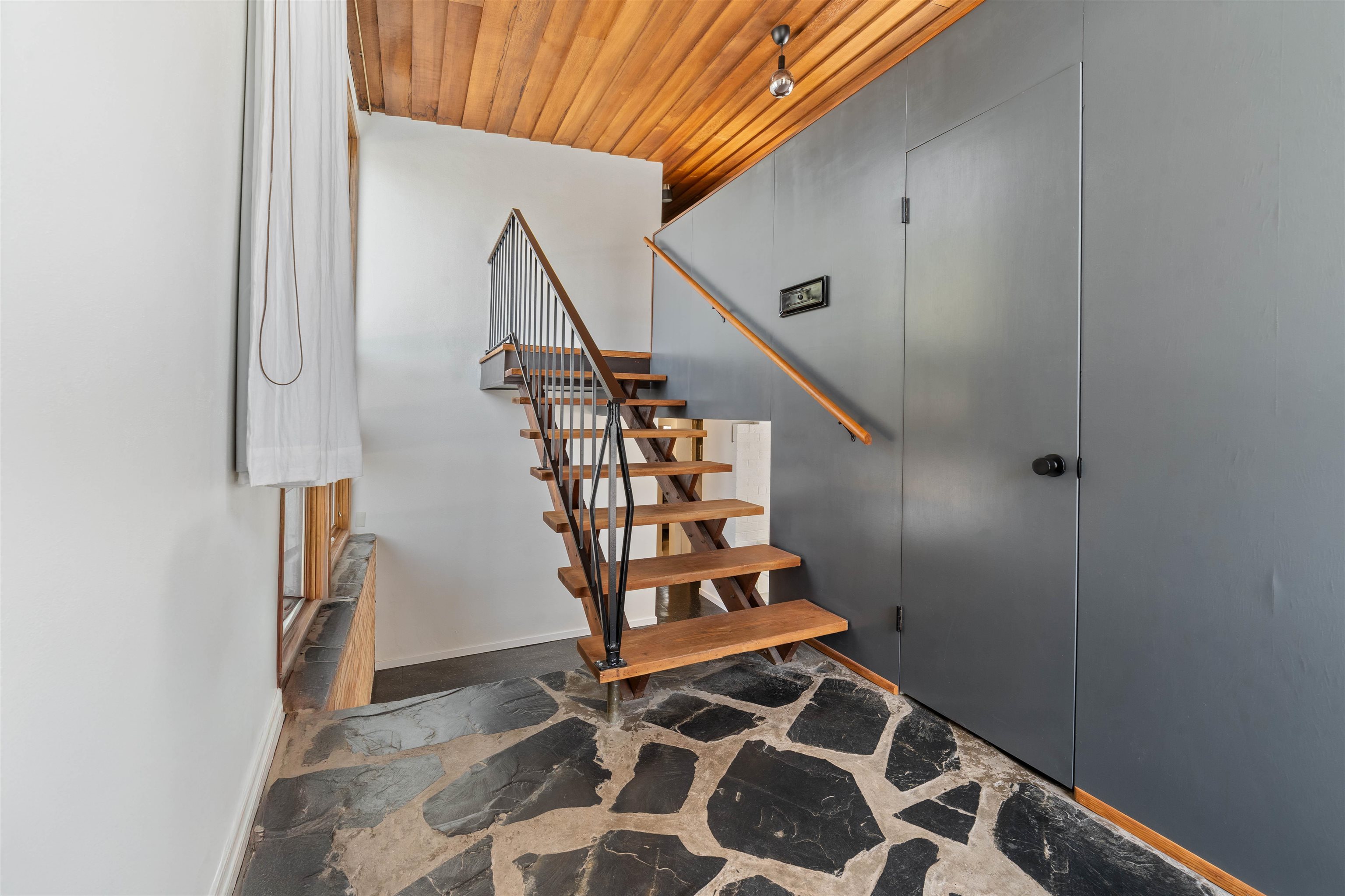 26 Riverside Road Esko, MN 55733 - Photo 3 of 34 Stairs featuring stone finish floor, wood ceiling, and baseboards