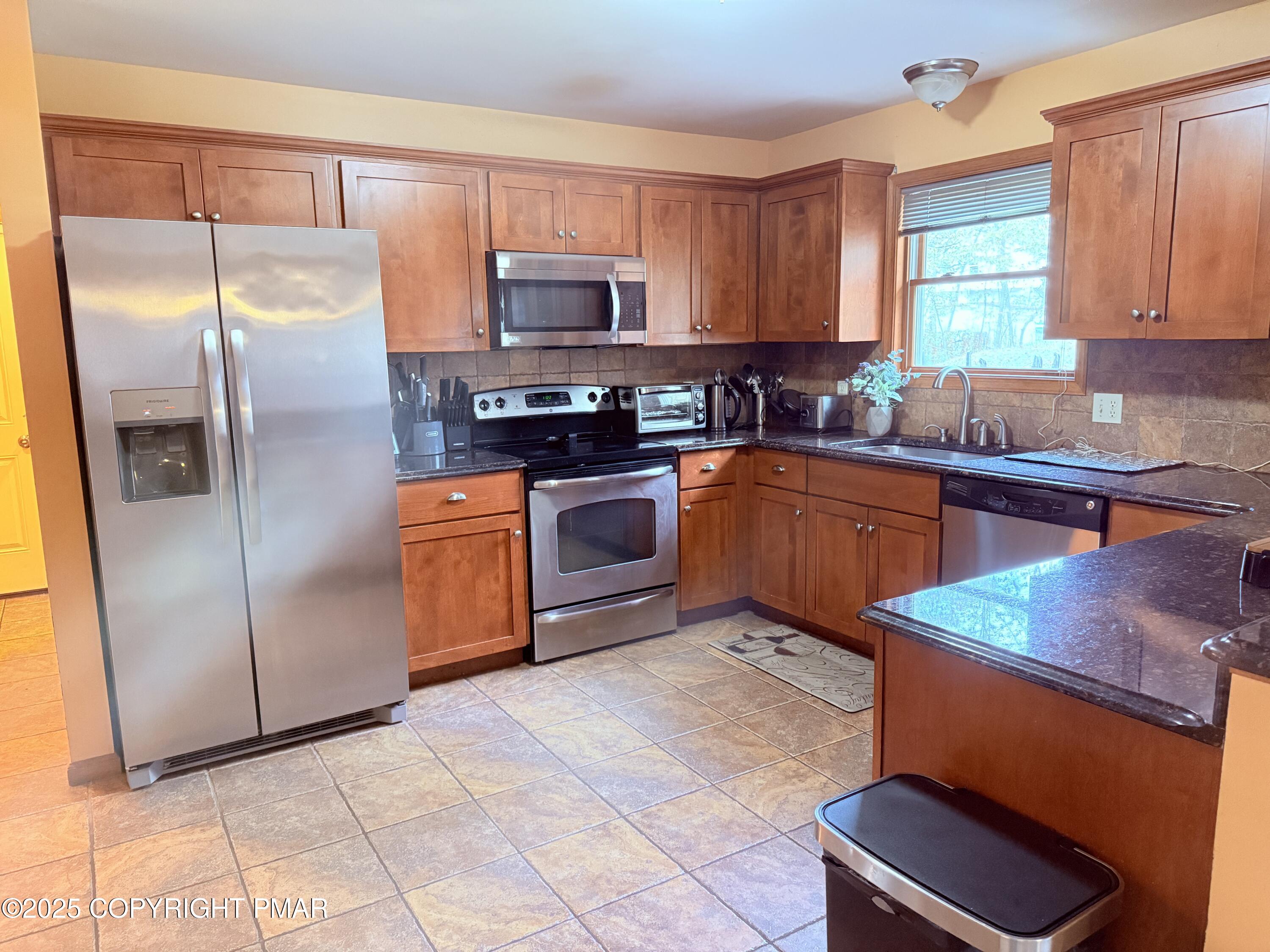 238 Dorset Road Tobyhanna, PA 18466 - Photo 4 of 24 a kitchen with stainless steel appliances granite countertop a stove a sink dishwasher a refrigerator and a microwave