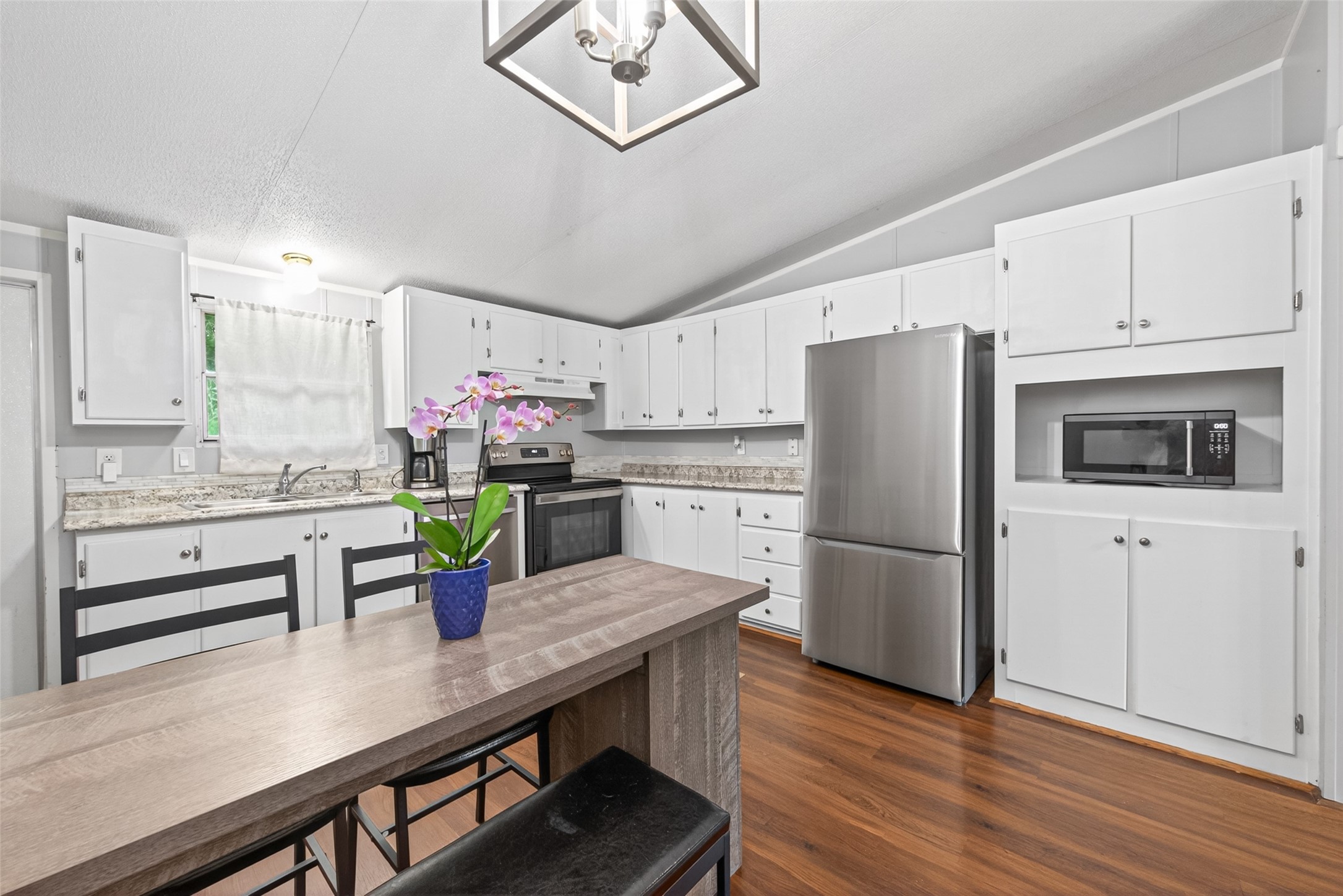 16572 River Ranch Drive Conroe, TX 77302 - Photo 5 of 18 a kitchen with refrigerator cabinets and wooden floor