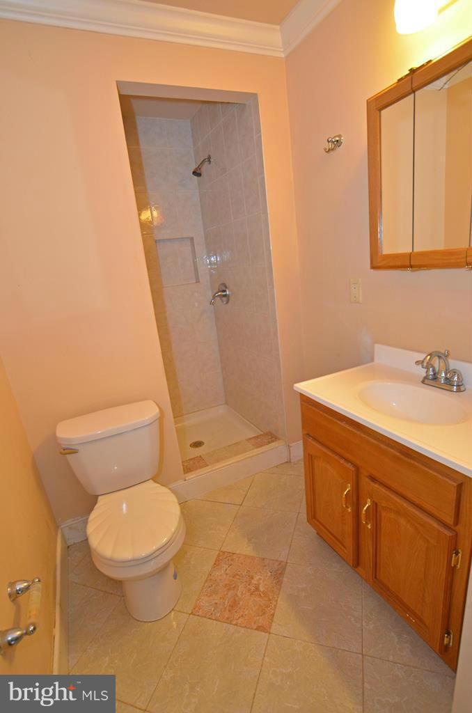 4618 Tema Road Pikesville, MD 21208 - Photo 11 of 29 a bathroom with a granite countertop toilet sink and mirror