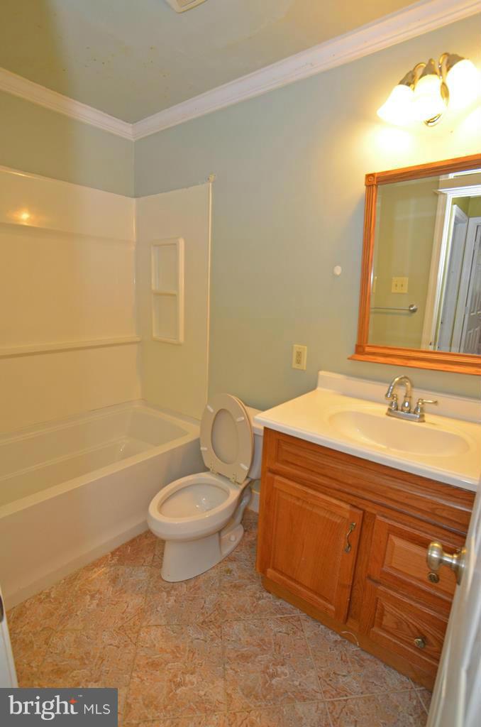 4618 Tema Road Pikesville, MD 21208 - Photo 14 of 29 a bathroom with a granite countertop sink toilet and shower