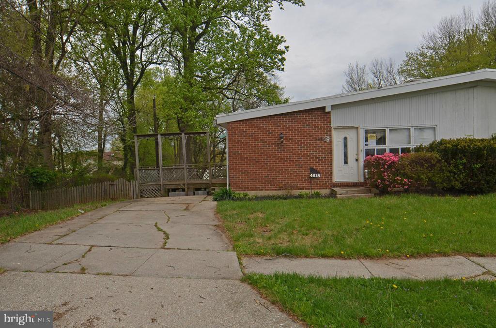 4618 Tema Road Pikesville, MD 21208 - Photo 24 of 29 a view of backyard with potted plants and large tree