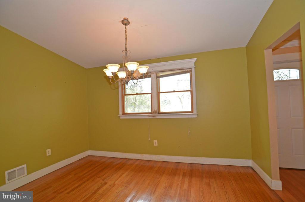 4618 Tema Road Pikesville, MD 21208 - Photo 5 of 29 a view of empty room with wooden floor and fan