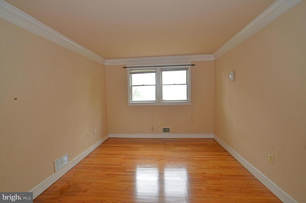 4618 Tema Road Pikesville, MD 21208 - Photo 9 of 29 wooden floor in an empty room with a window