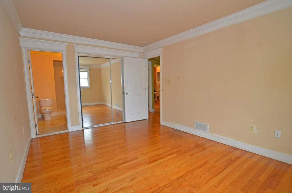 4618 Tema Road Pikesville, MD 21208 - Photo 10 of 29 a view of an empty room with wooden floor and a window