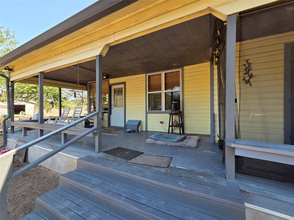 150 Beaver Road Elgin, TX 78621 - Photo 14 of 40 a porch with wooden floor and glass door