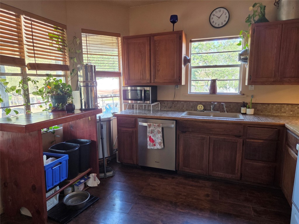 150 Beaver Road Elgin, TX 78621 - Photo 17 of 40 a kitchen with sink cabinets and window
