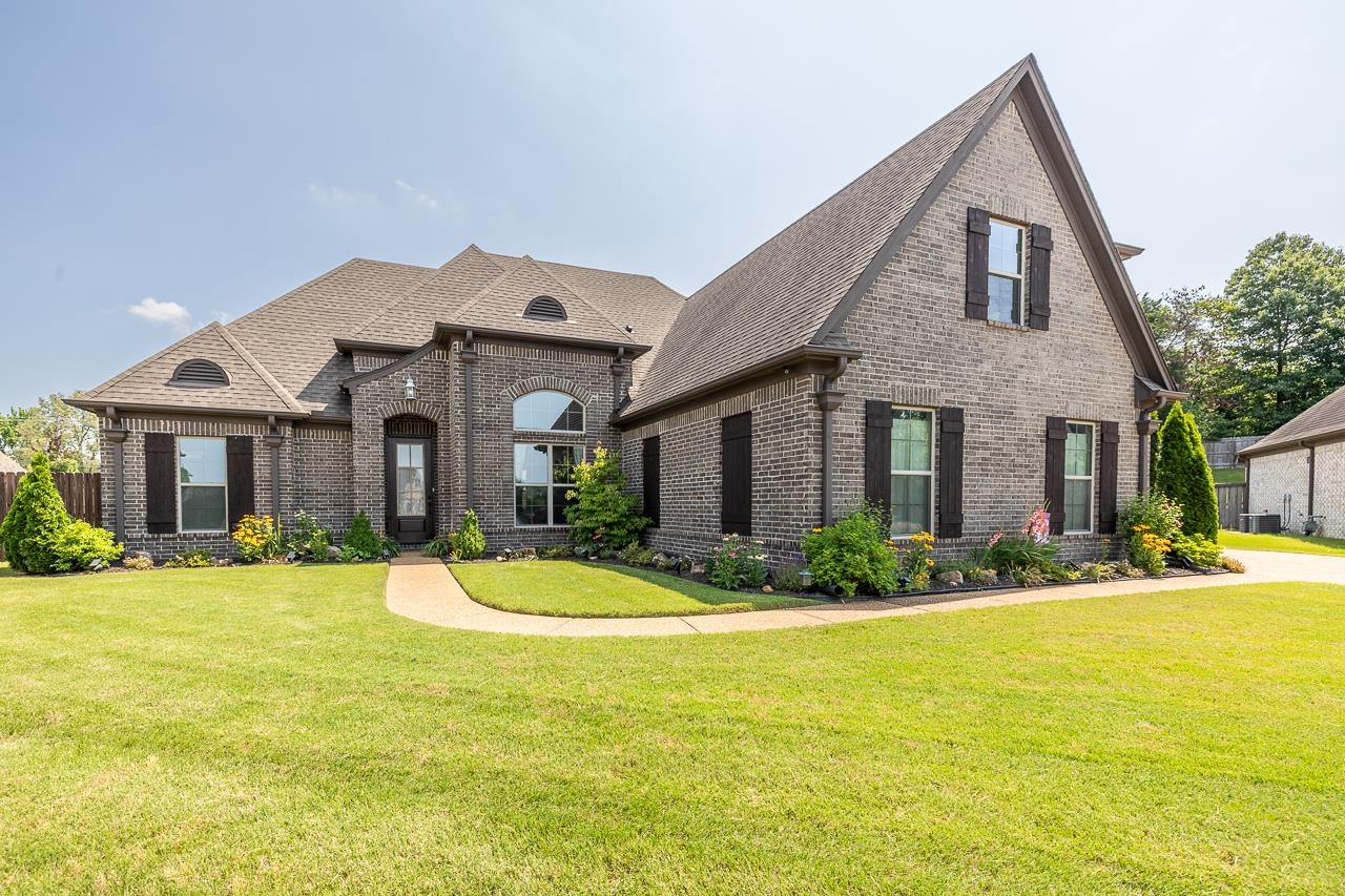 a front view of house with yard and green space