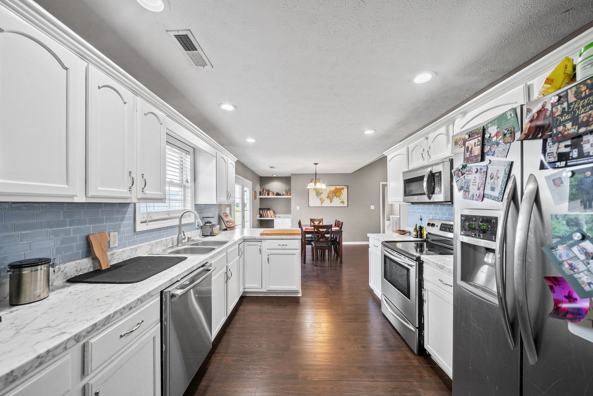 1940 Loop Lane Gracey, KY 42232 - Photo 12 of 32 a kitchen with stainless steel appliances granite countertop a lot of counter space and wooden floors