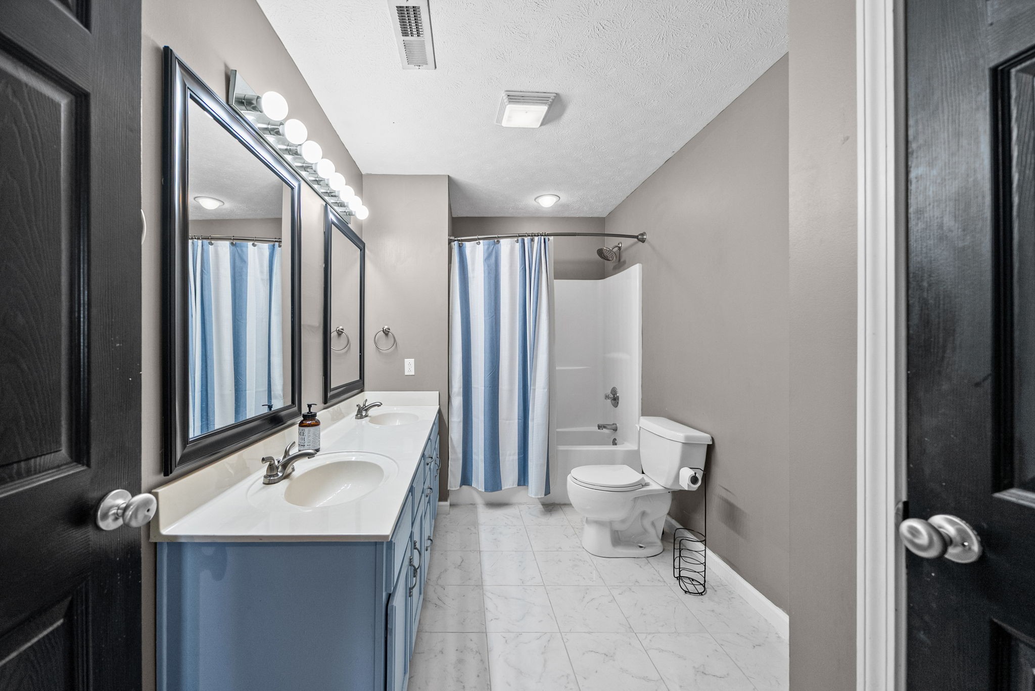 1940 Loop Lane Gracey, KY 42232 - Photo 17 of 32 a bathroom with a double vanity sink toilet and mirror