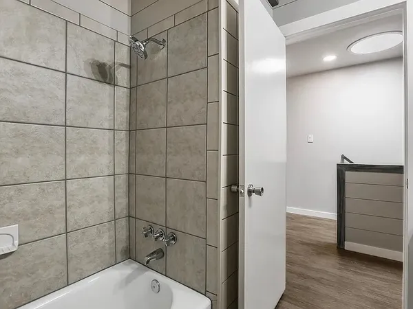 a bathroom with a bathtub and shower