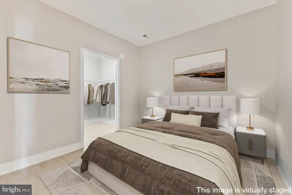 a bedroom with a bed and a painting on the wall