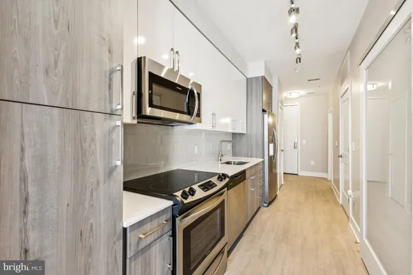 a kitchen with stainless steel appliances granite countertop a stove and a refrigerator