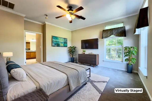 a bedroom with a bed flat screen tv and a fireplace
