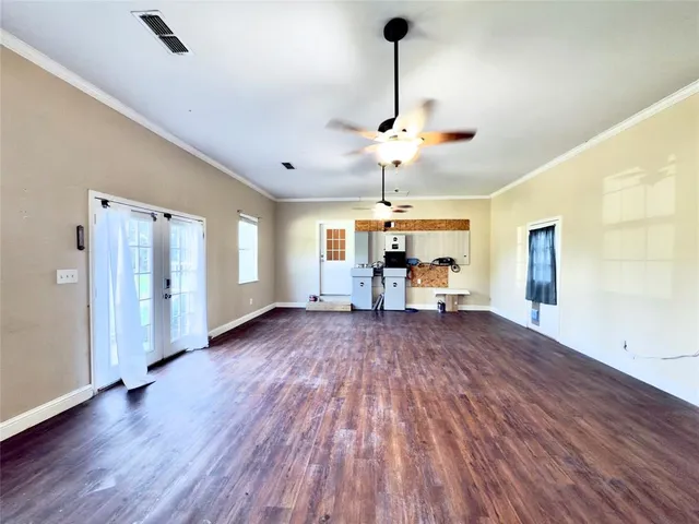 a view of a livingroom with furniture wooden floor a chandelier