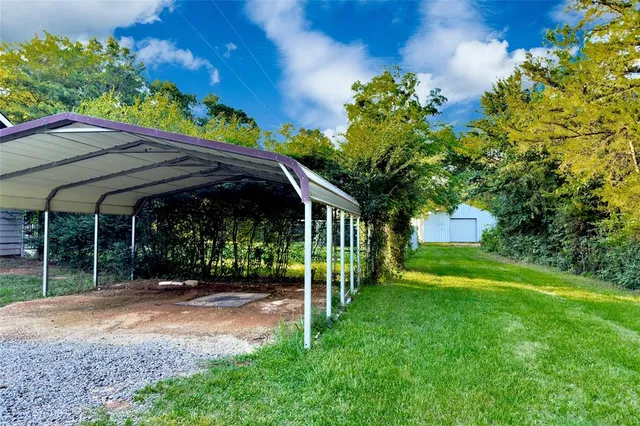 a view of a chair and table in the garden