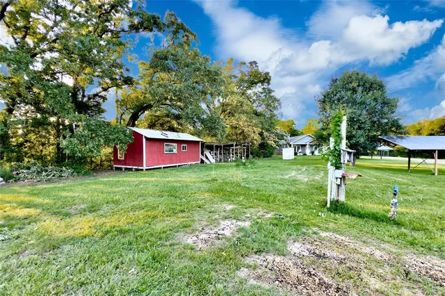 a view of a backyard with sitting area