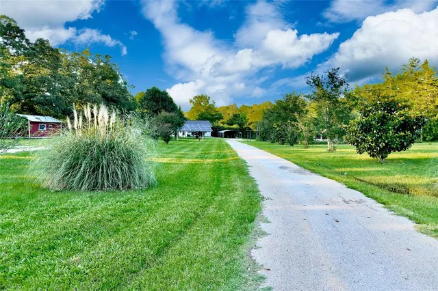a view of a street with a big yard