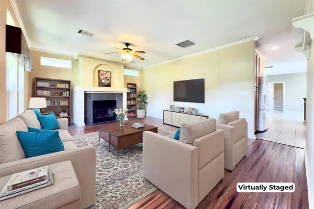 a living room with furniture a flat screen tv and a fireplace