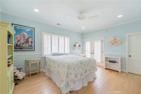 a spacious bedroom with two beds and a large window