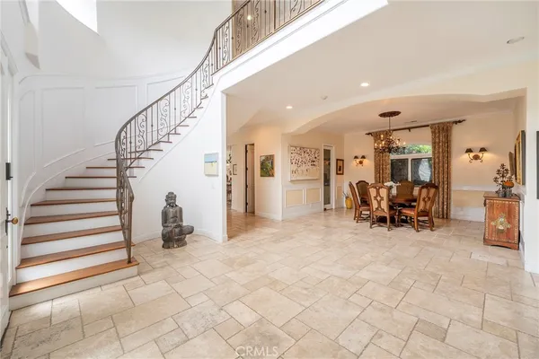 a view of a livingroom with furniture and staircase