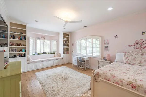 a bedroom with a bed and a flat tv screen on dresser