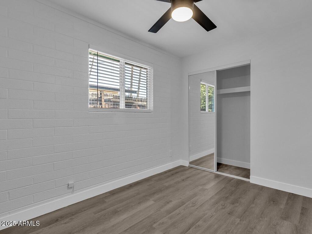 3116 North 39th Street Phoenix, AZ 85018 - Photo 16 of 22 wooden floor in an empty room with a window