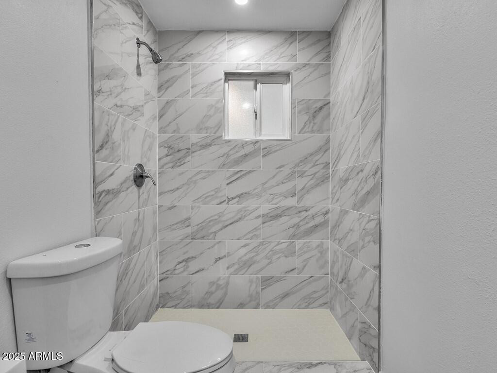 3116 North 39th Street Phoenix, AZ 85018 - Photo 18 of 22 a bathroom with a toilet and a shower