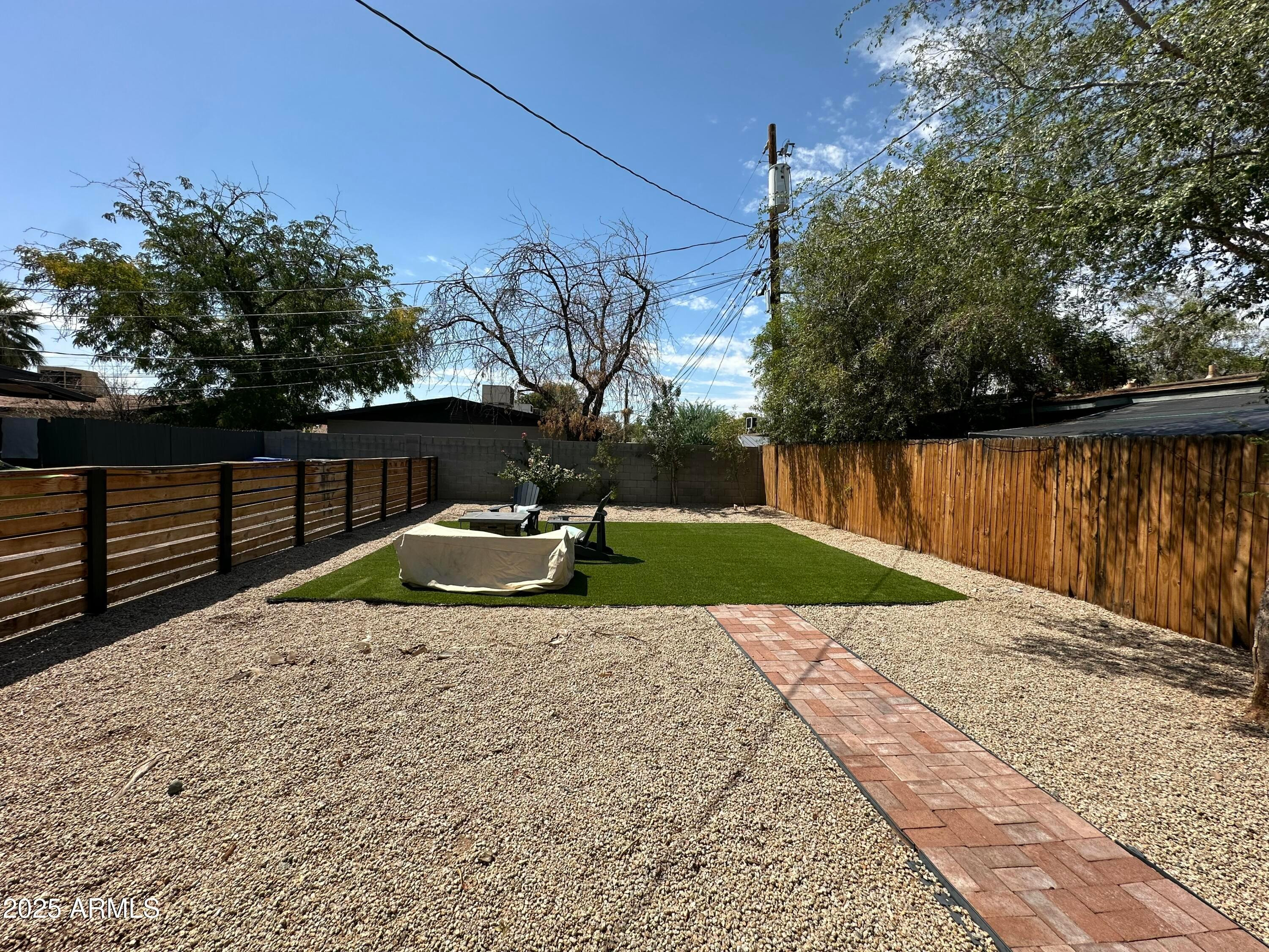 3116 North 39th Street Phoenix, AZ 85018 - Photo 20 of 22 a view of a backyard with wooden fence