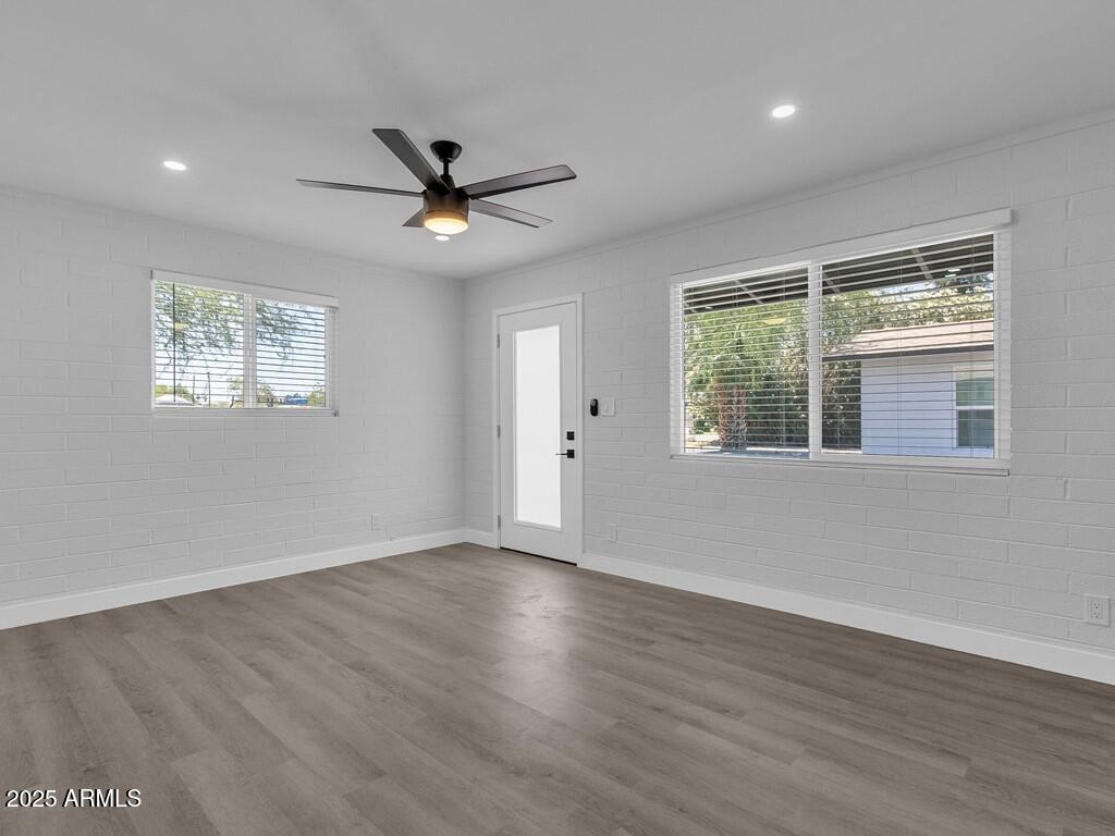 3116 North 39th Street Phoenix, AZ 85018 - Photo 6 of 22 a view of an empty room with wooden floor and a window