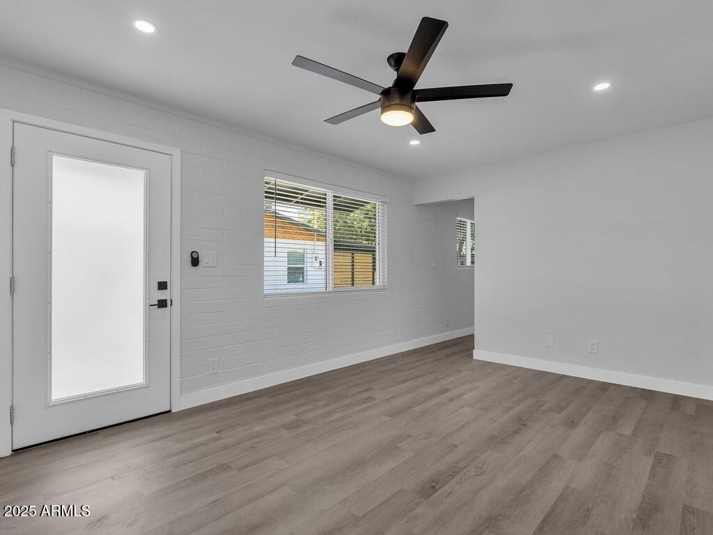 3116 North 39th Street Phoenix, AZ 85018 - Photo 7 of 22 a view of a livingroom with a ceiling fan and wooden floor