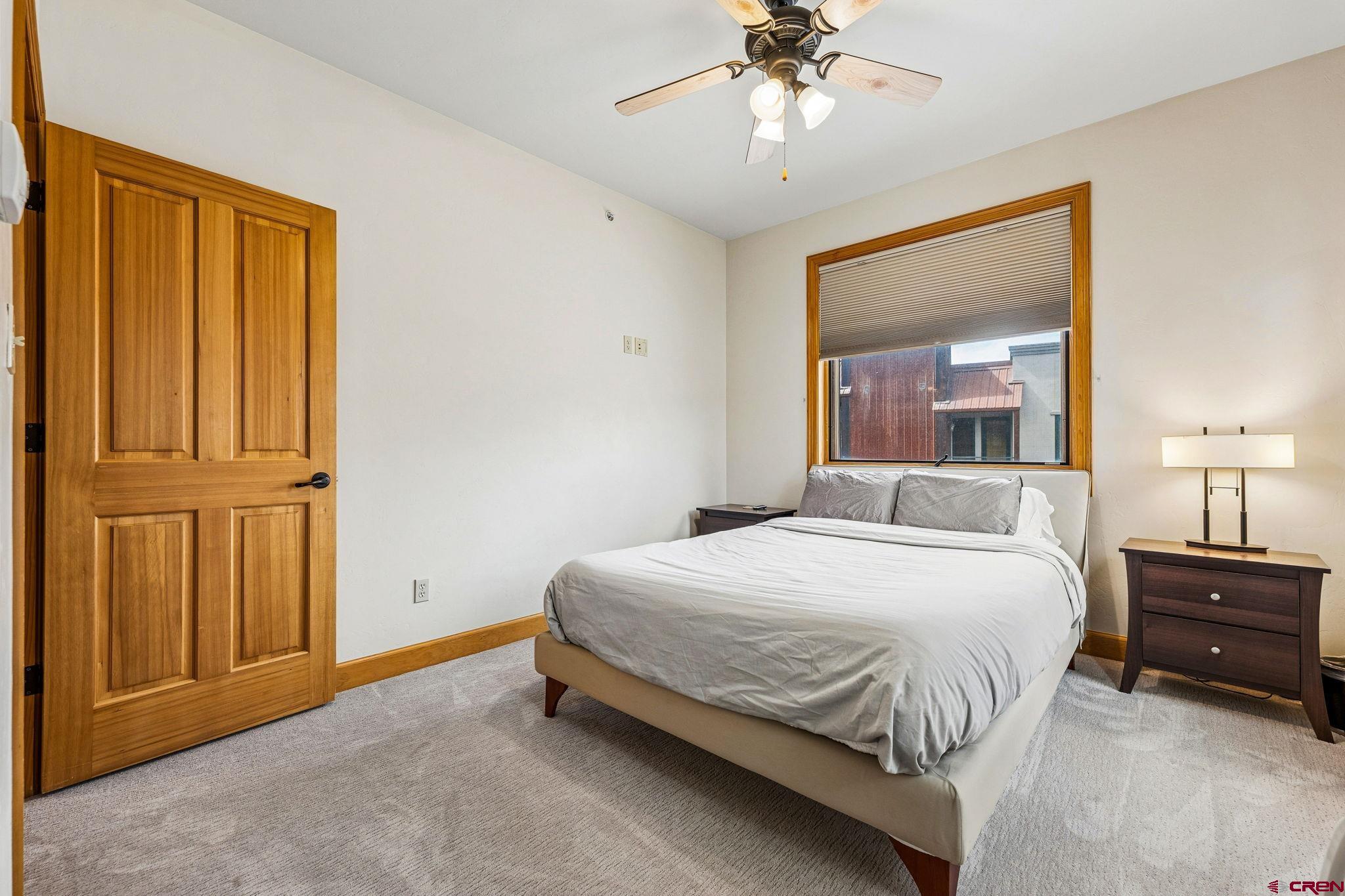 1422 Animas View Drive, Unit 55 Durango, CO 81301 - Photo 32 of 44 a bedroom with a bed and a chandelier