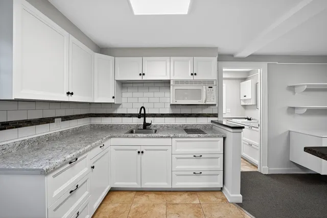 a kitchen with a sink and cabinets