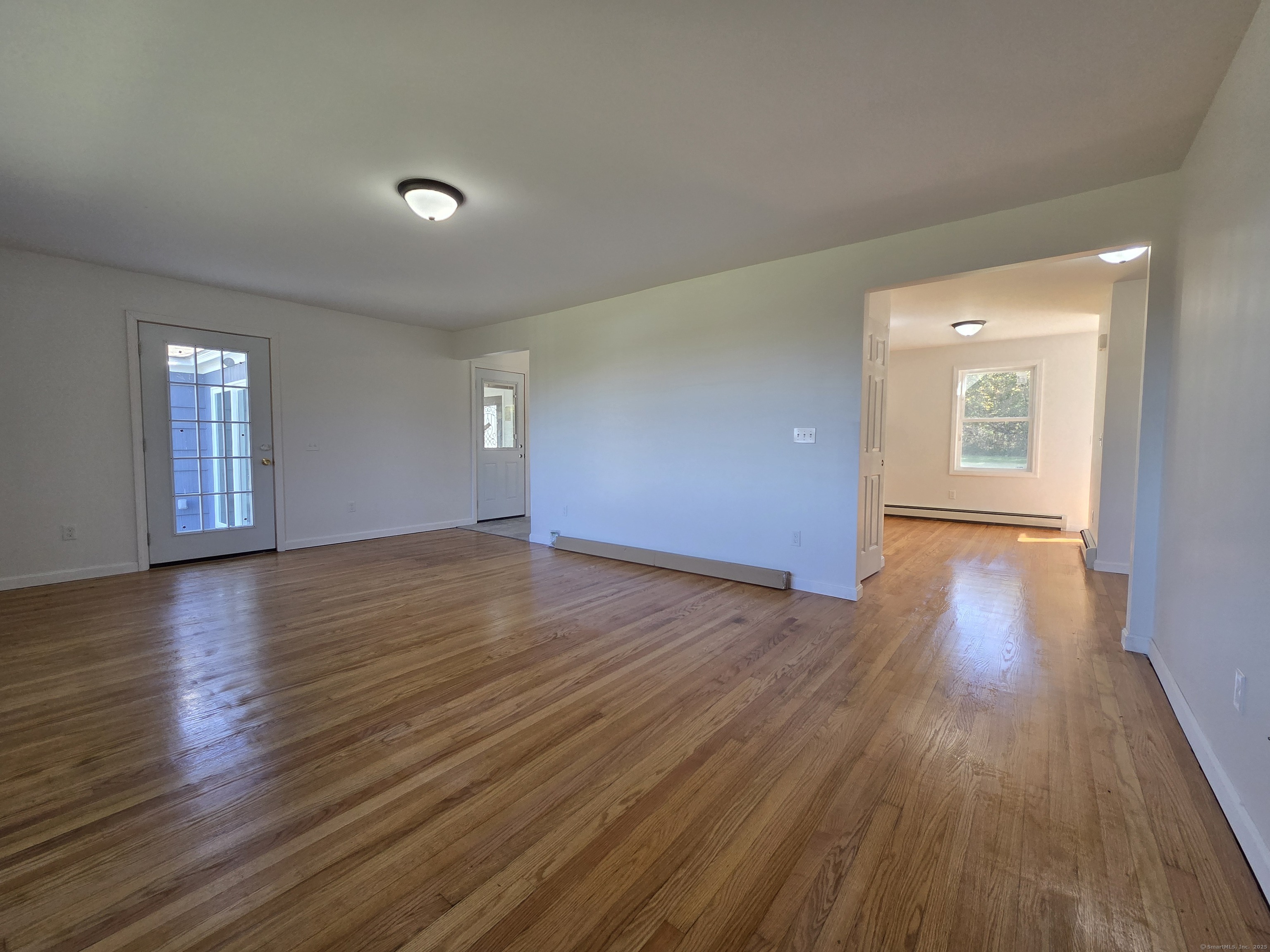 395 Bailey Hill Road Killingly, CT 06239 - Photo 11 of 36 a view of an empty room with wooden floor and a window