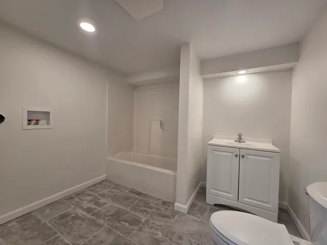 a bathroom with a toilet a sink and shower