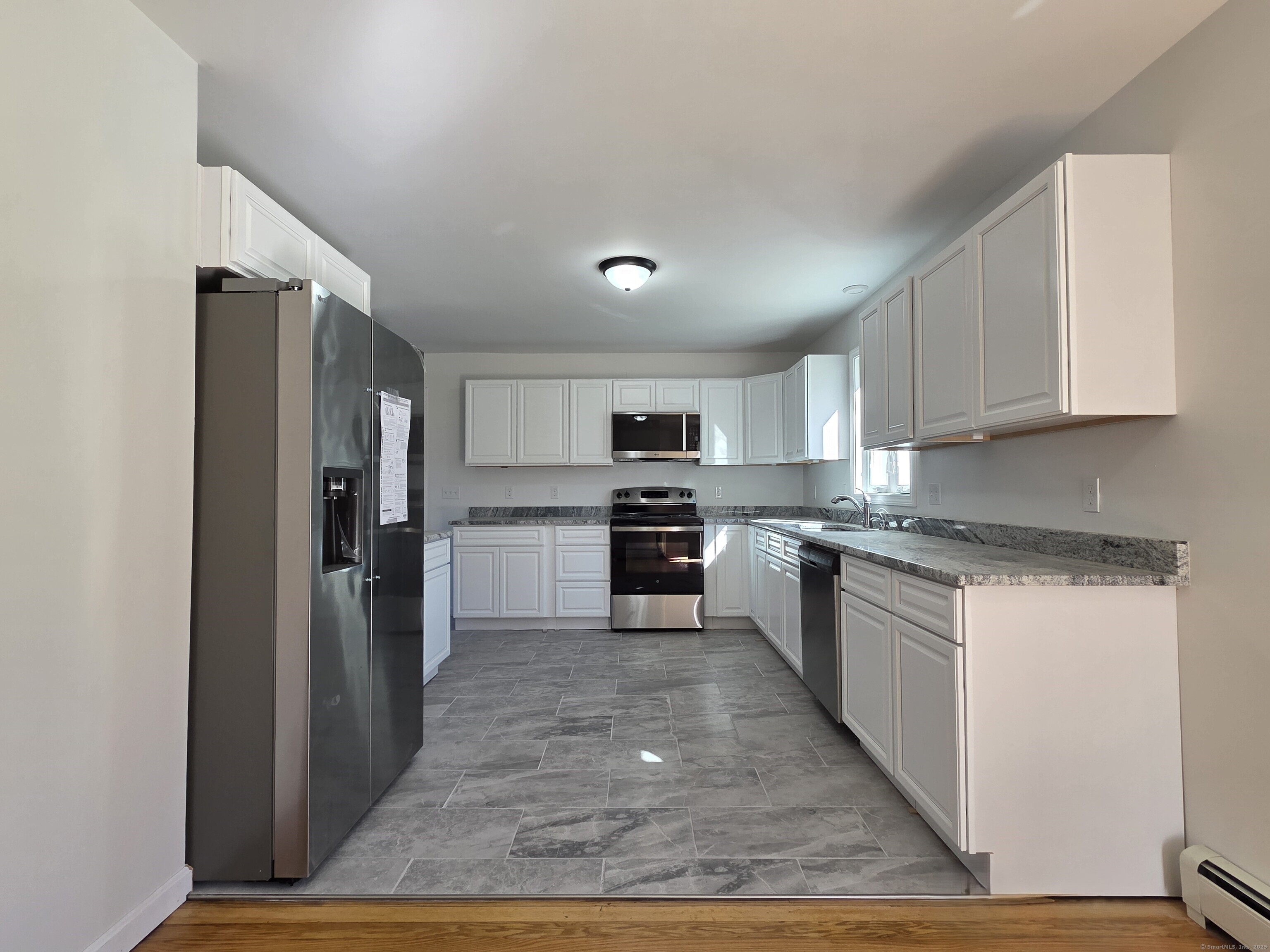 395 Bailey Hill Road Killingly, CT 06239 - Photo 7 of 36 a large kitchen with cabinets and stainless steel appliances