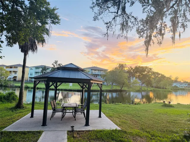 a view of a lake with a table and a chairs