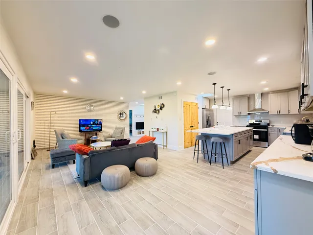 a living room with furniture and kitchen view