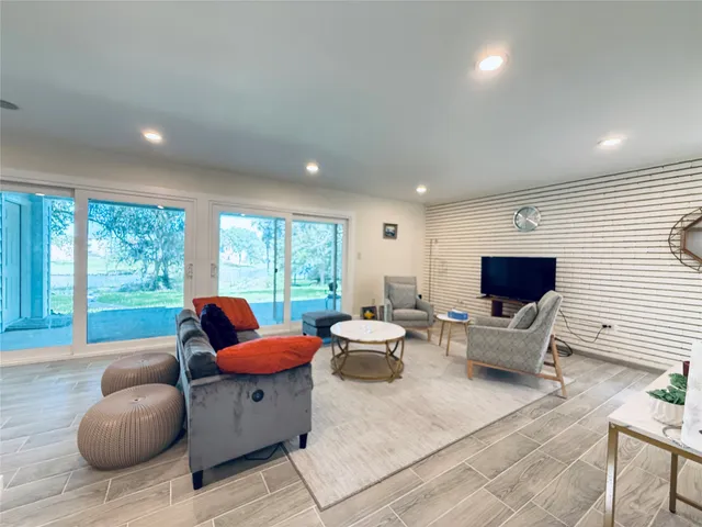 a living room with furniture and large windows