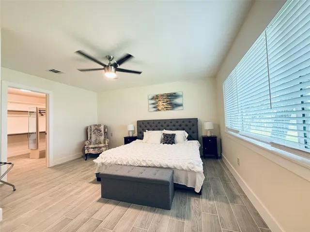 a bedroom with bed and window